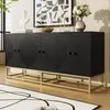 A black sideboard with gold legs is displayed in a room with a rug and artwork. Voir les images du produit