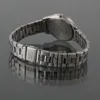 A watch with a metal band on a reflective surface. Podgląd zdjęcia produktu