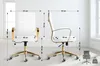 Two views of a white office chair with gold accents, with dimensions indicated by lines and text. Podgląd zdjęcia produktu