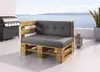 An outdoor patio with a grill, a pallet sofa, and a view of the ocean. Produktbild-Vorschau