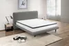 A mattress on a bed frame in a bedroom setting. Náhľad obrázku produktu