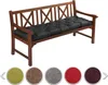 A wooden bench with a black cushion on it, with color swatches below.
