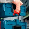 A hand is shown connecting two blue Bosch L-Boxx tool cases together. Podgląd zdjęcia produktu
