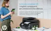 A woman is holding an HP ink cartridge next to an HP printer. Náhľad obrázku produktu