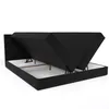 A black upholstered bed frame with the mattress and topper lifted to reveal the storage compartments underneath. Produktbild-Vorschau