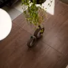 A close-up overhead view of a wooden table with two decorative vases and some greenery. Produktbild-Vorschau