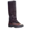 A pair of black gaiters worn over brown hiking boots, shown against a white background. Anteprima dell’immagine prodotto
