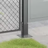 Close-up of a metal post base on a concrete surface with grass in the foreground. Produktbild-Vorschau