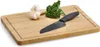 A cutting board with a knife, garlic, and parsley on it. Anteprima dell’immagine prodotto