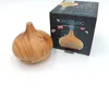 A wooden-style aroma diffuser is placed next to its packaging box on a white background. Podgląd zdjęcia produktu