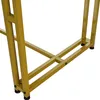 A close-up view of the golden metal legs of a table. Podgląd zdjęcia produktu