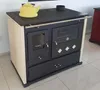 A kitchen stove with a yellow kettle on top, placed indoors on a tiled floor. Produktbild-Vorschau