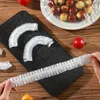 A hand is holding a disposable food wrap on a wooden table. Náhled obrázku produktu