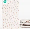 A folded fitted sheet with a cute tiger spot pattern and an OEKO-TEX certification label. Produktbild-Vorschau