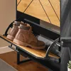 A close-up view of a shoe cabinet with two brown boots on one of its shelves. Produktbild-Vorschau