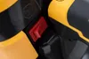 A close-up of a red on/off switch on a black and yellow piece of equipment. Produktbild-Vorschau