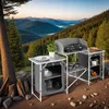 A camping kitchen set up outdoors with a scenic mountain and forest background. Voir les images du produit