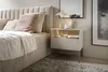 A bedroom scene featuring a nightstand next to a bed. Produktbild-Vorschau