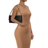 A woman wearing a brown dress is holding a black clutch bag. Produktbild-Vorschau
