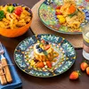 A table setting with plates of food and cutlery. Náhled obrázku produktu