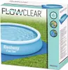 The image shows the packaging of a Bestway Flowclear pool ground cloth on a grassy surface. Produktbild-Vorschau