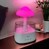 A mushroom-shaped humidifier with pink LED light is placed on a wooden surface next to a plant and books. Náhled obrázku produktu