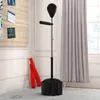 A boxing stand with a punching bag and reflex bar is set up in a room with a bulletin board and curtains. Produktbild-Vorschau