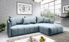 A light blue sectional sofa in a modern living room setting, with a brick wall and a large window in the background.