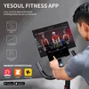 A person is using a stationary exercise bike with a large screen displaying a fitness app. Náhled obrázku produktu