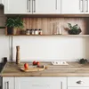 A kitchen counter with a wooden cutting board, tomatoes, a pepper mill, and a built-in power outlet. Produktbild-Vorschau