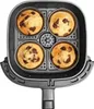 A top-down view of an air fryer basket with four chocolate chip muffins inside. Produktbild-Vorschau