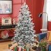 A decorated Christmas tree in a room with red walls and a black console table. Náhled obrázku produktu