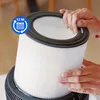 A person's hands are holding an air purifier filter. Produktbild-Vorschau