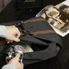 A person is taking a vintage camera out of a black backpack with brown leather accents. Produktbild-Vorschau