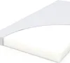 A close-up, angled view of a white mattress with a light gray cover partially pulled back. Voir les images du produit