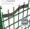 A close-up of a green fence with a gray privacy strip being threaded through it, with an arrow indicating direction. A small inset image shows a section of the fence with the privacy strip installed. Náhled obrázku produktu