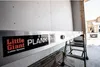 A plank is attached to a wall, supported by a ladder. Produktbild-Vorschau