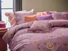 A close-up view of a bed with multiple pillows and a duvet cover. Produktbild-Vorschau