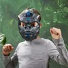 A child wearing a Transformers Optimus Primal mask in a jungle-like setting. Produktbild-Vorschau