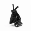 A folded black stroller on a white background. Náhľad obrázku produktu