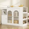 A white sideboard with glass doors and open shelving, styled in a living room or dining area. Produktbild-Vorschau