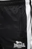 A close-up view of black track pants with a white stripe and a zipped pocket. Anteprima dell’immagine prodotto