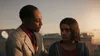 Two people are standing on a rooftop at sunset. Podgląd zdjęcia produktu