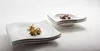 Two stacks of white square plates, each with a small portion of food on the top plate. Podgląd zdjęcia produktu