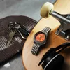 A watch, keys, beanie, and headphones are arranged on a skateboard. Podgląd zdjęcia produktu