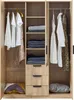 An open wardrobe with clothes hanging and folded, and drawers. Anteprima dell’immagine prodotto