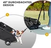 A dog is running out of a black dog stroller, while a person is holding the handle of the stroller. Produktbild-Vorschau