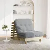 A futon sofa is shown in a room with shelves in the background. Voir les images du produit