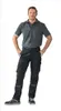 A man wearing black work pants and a gray polo shirt, posing with his hands on his hips. Anteprima dell’immagine prodotto