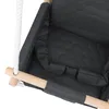 A close-up view of a dark gray baby swing seat with a wooden support bar and a white rope. Produktbild-Vorschau